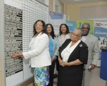 Natalia Gobin-Gunter Chairman and Deputy Managing director inserting name strip to indicate listing of Key Insurance on the junior market on Thursday